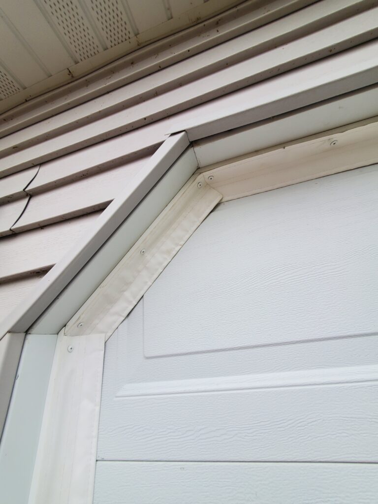 SnirtStopper SideSealer garage door seal installed on an angled corner